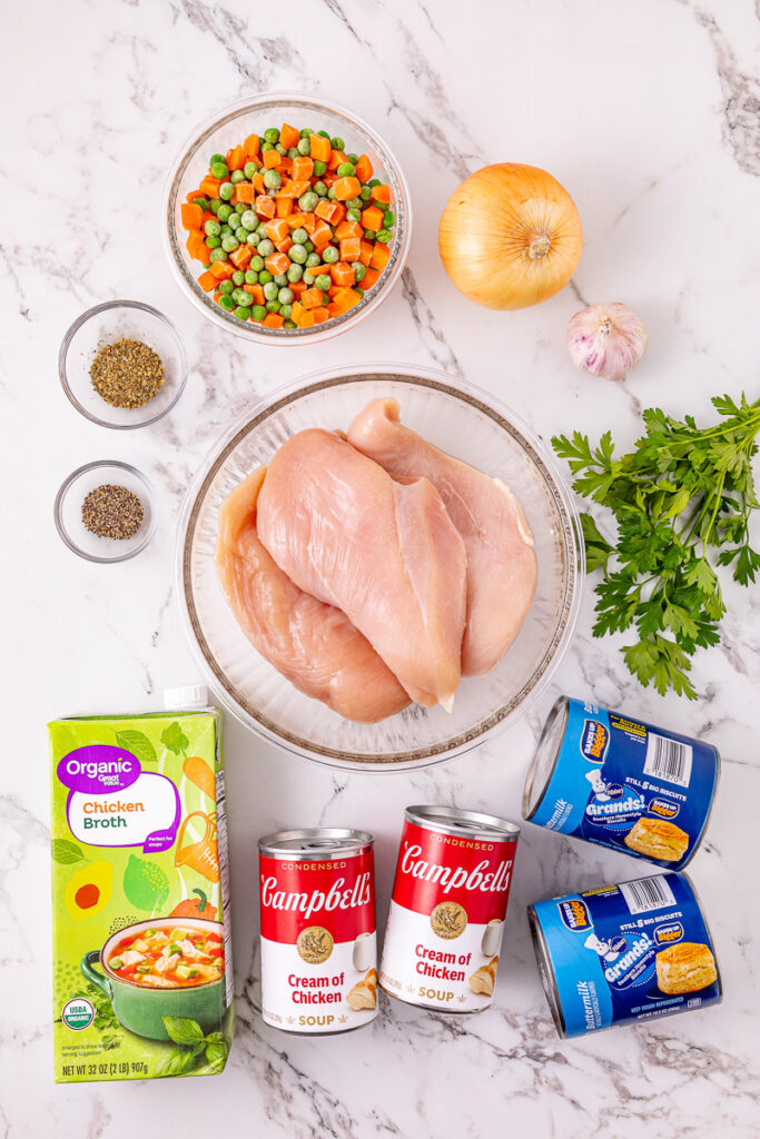 Ingredients for crockpot chicken and dumplings laid out on counter in preparation for the recipe.