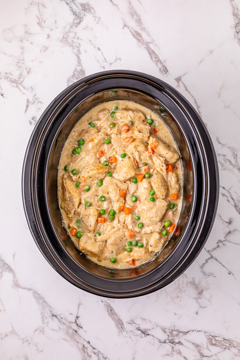 Once cooked, the bicuits are stirred into the chicken mixture in crockpot.