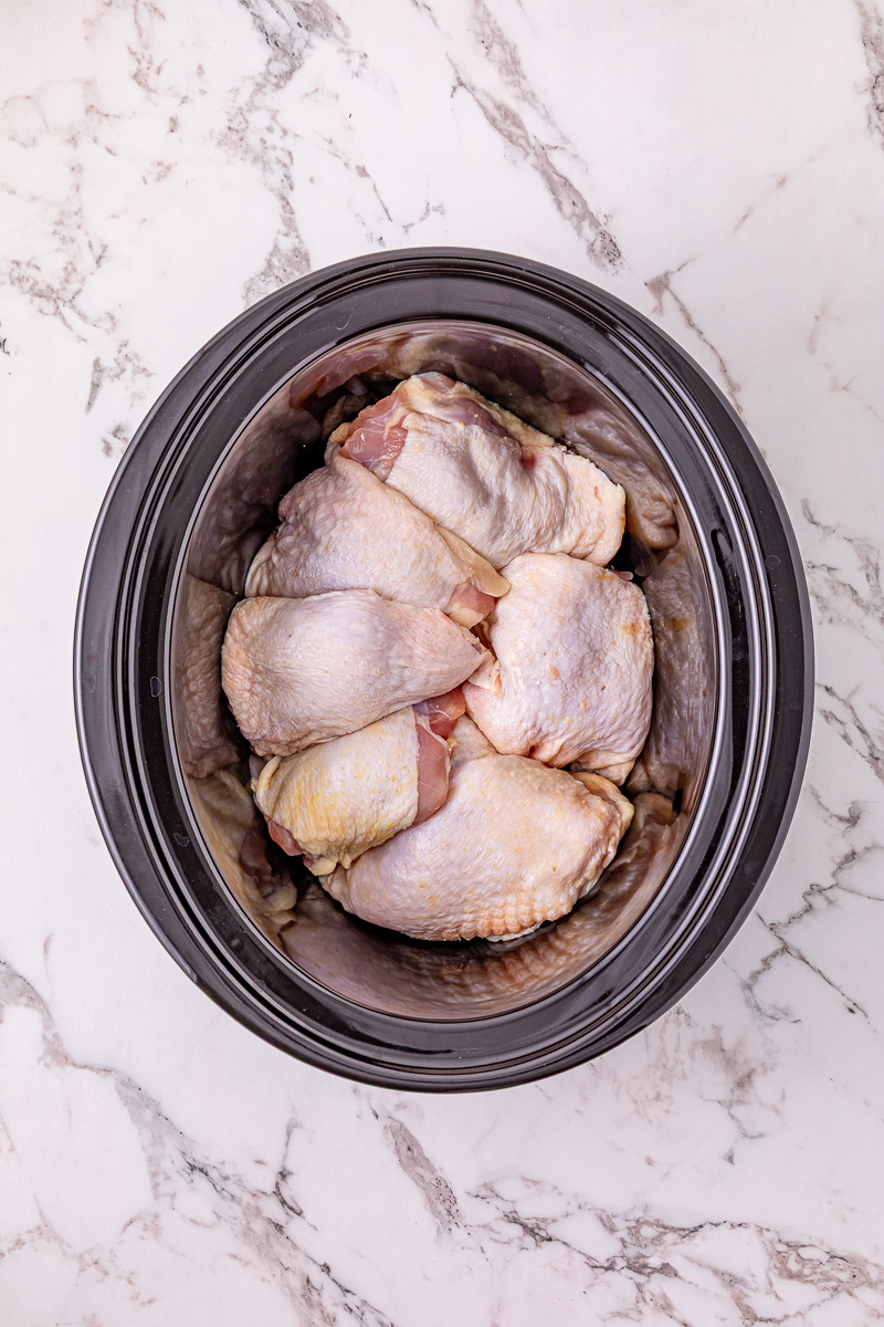 Crockpot jerk chicken thighs in slow cooker.