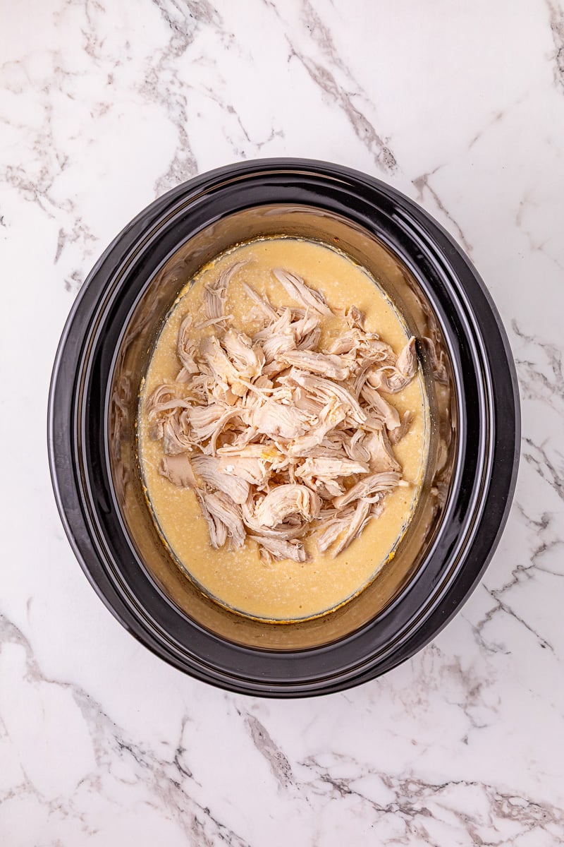 Chicken is added back to the crockpot.