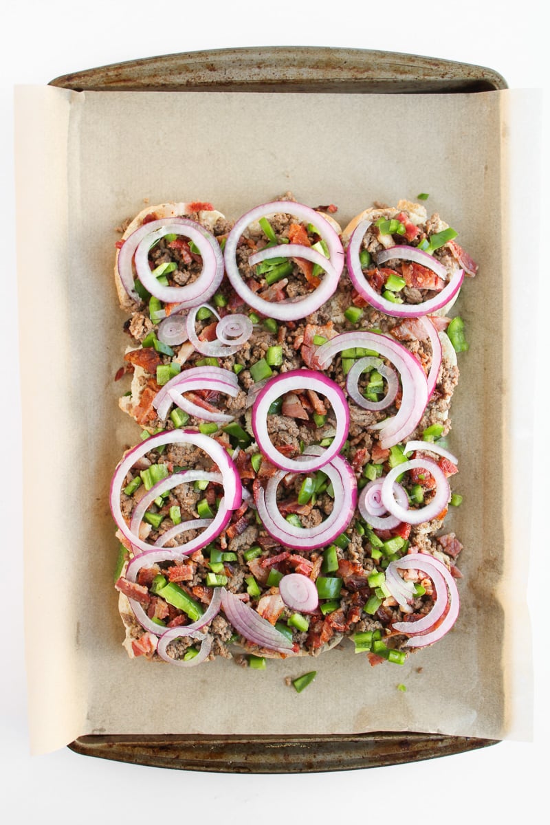 Sliced red onions on top of of ground beef mixture.