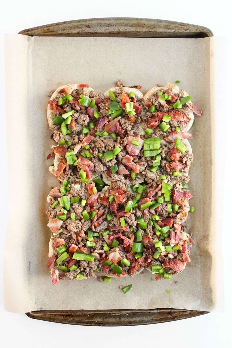 Ground beef mixture and crumbled bacon on top of slider buns.
