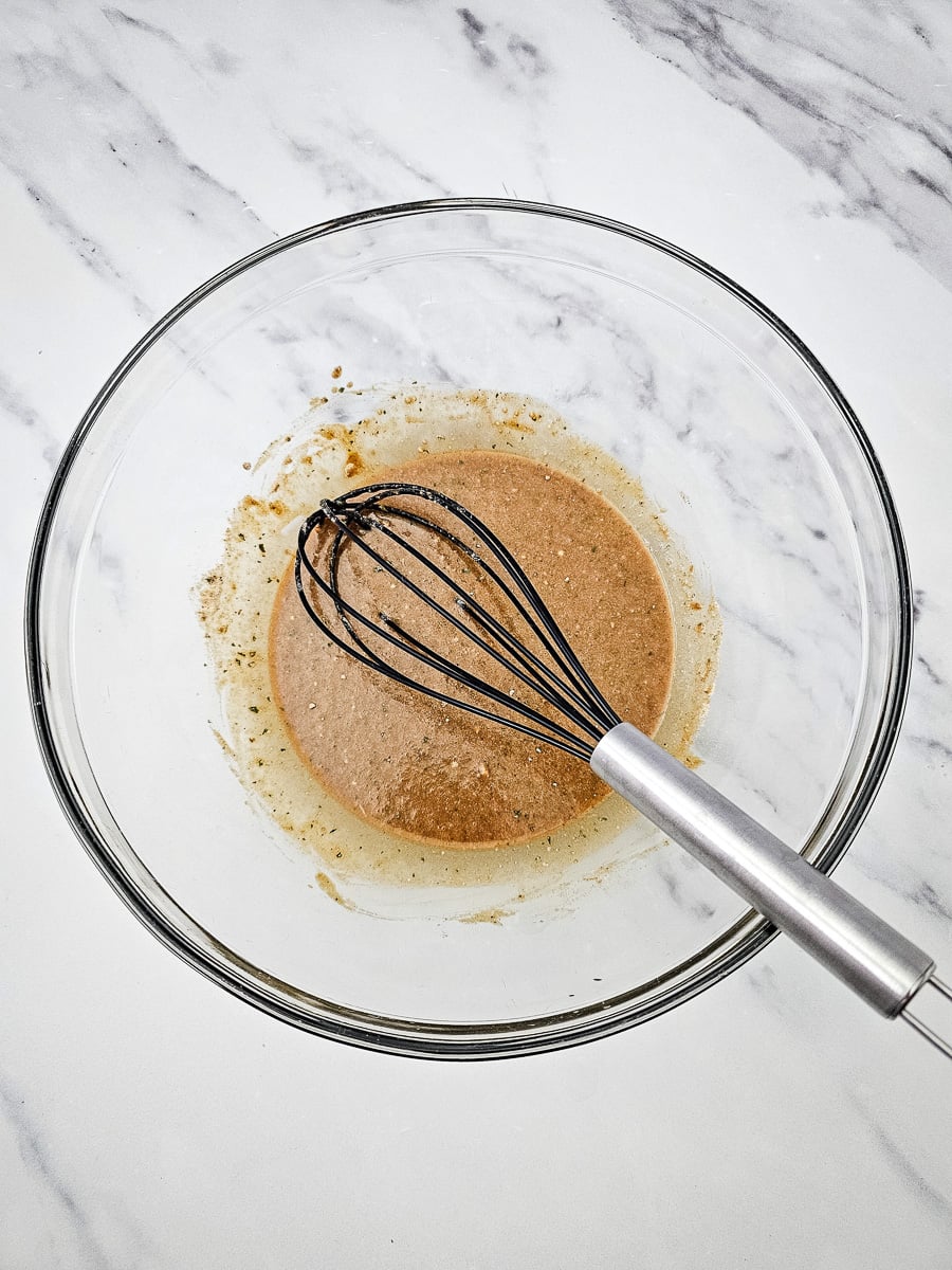 Pepperoncini juice and seasonings in glass bowl.