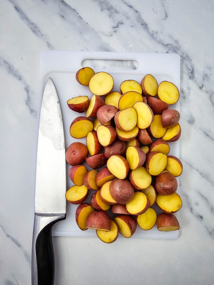Cut potatoes on cutting board.