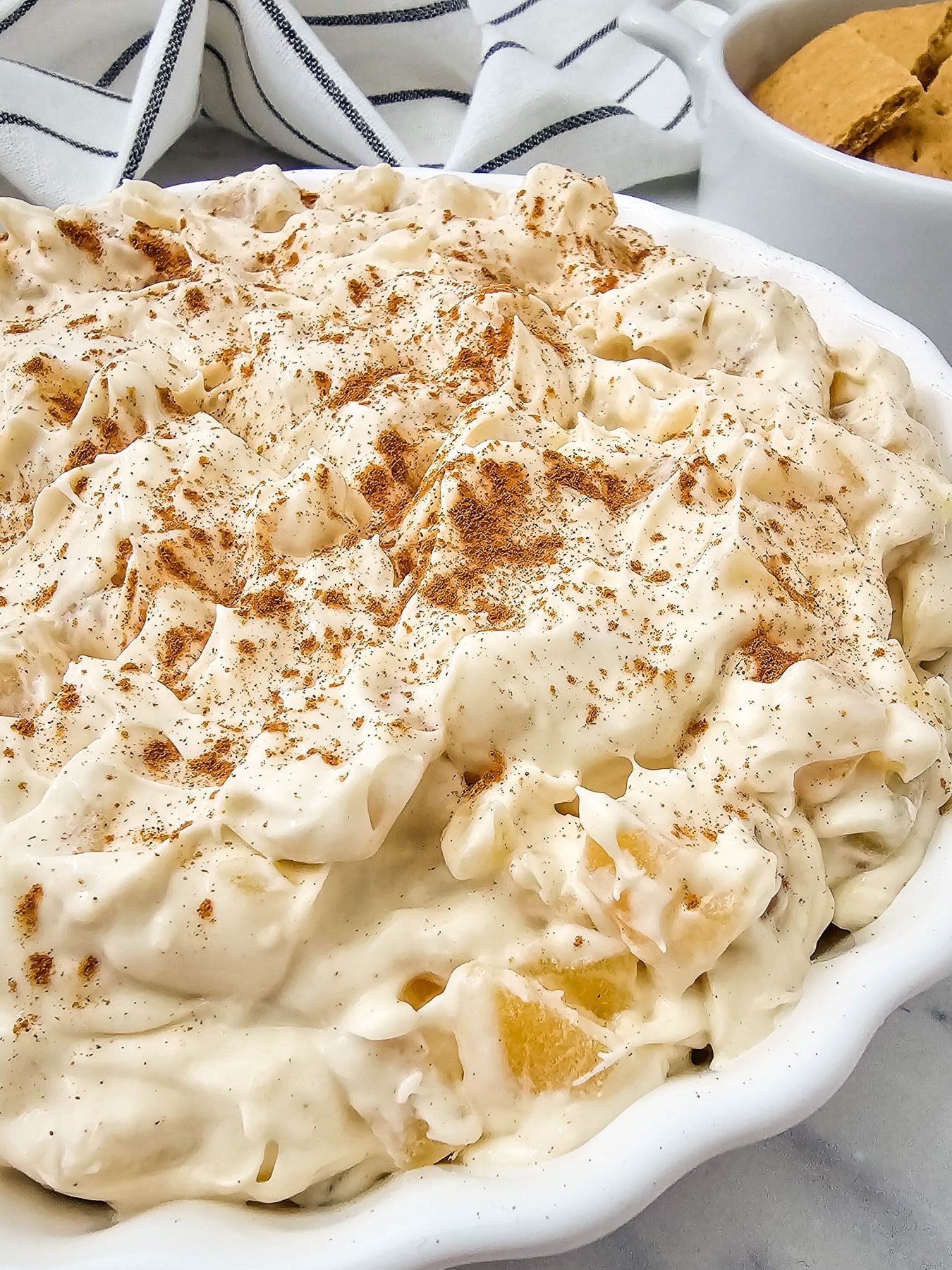 Apple pie dip in a white bowl.