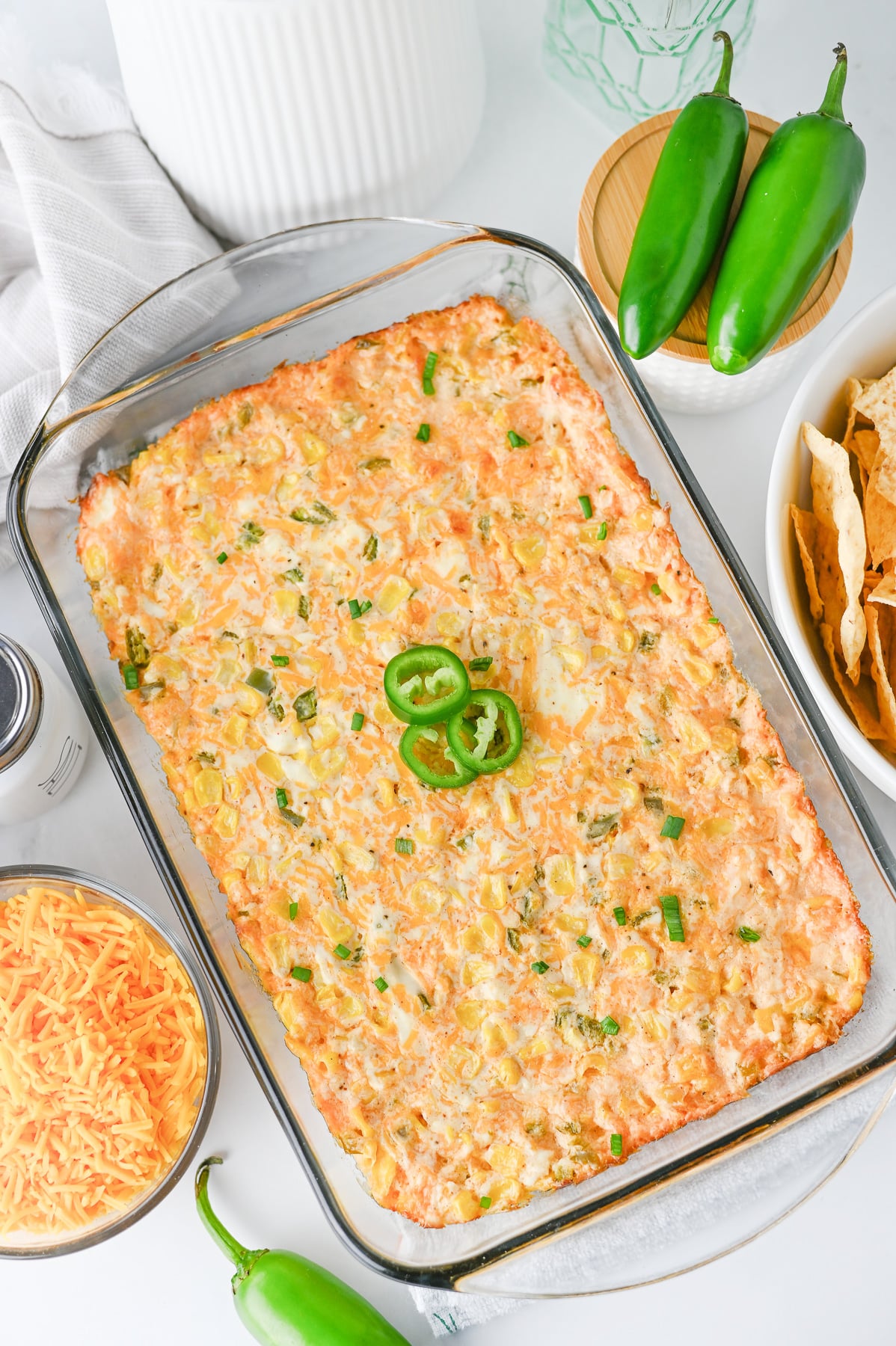 Hot jalapeno corn dip in glass baking dish, ready to be served.