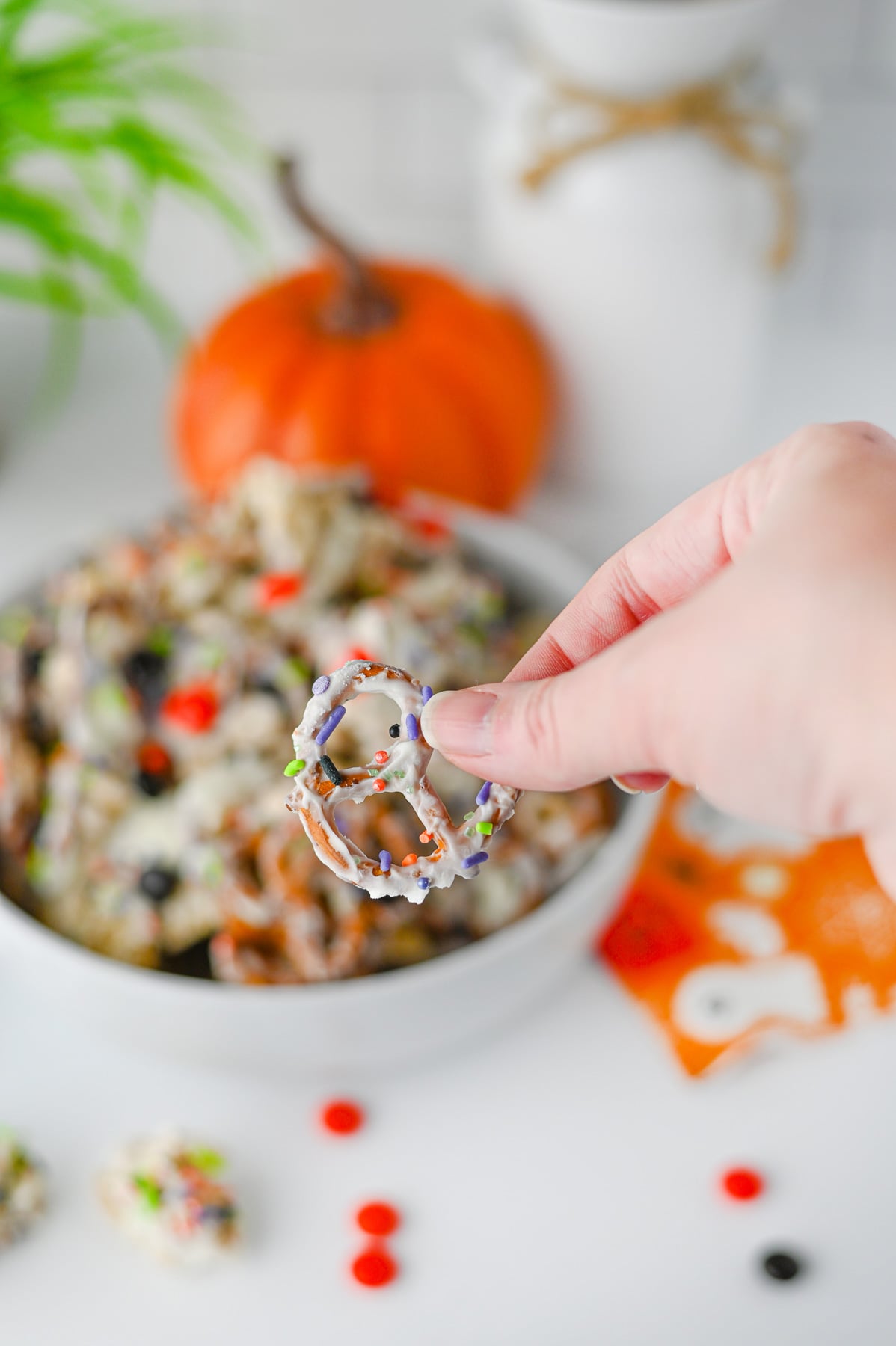 Monster munch snack mix close up image with fingers holding it.