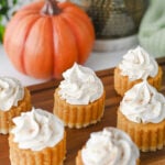 Pumpkin pie bites on wooden serving board.