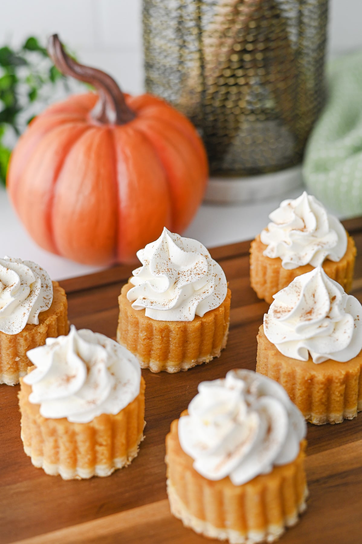 Pumpkin pie bites on a wooden serving platter for Thanksgiving dessert.