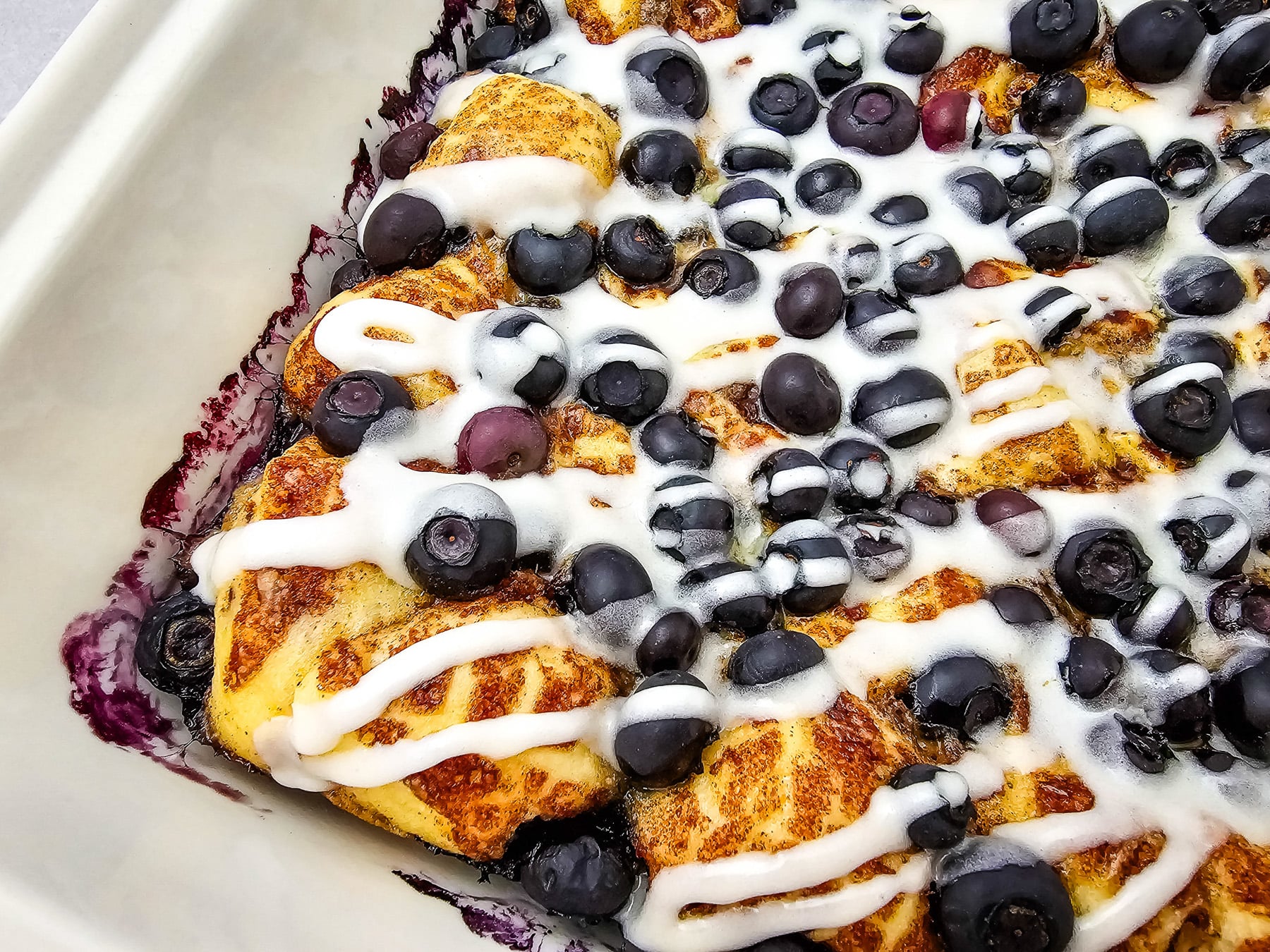 Blueberry cinnamon roll casserole in dish, ready to be served.
