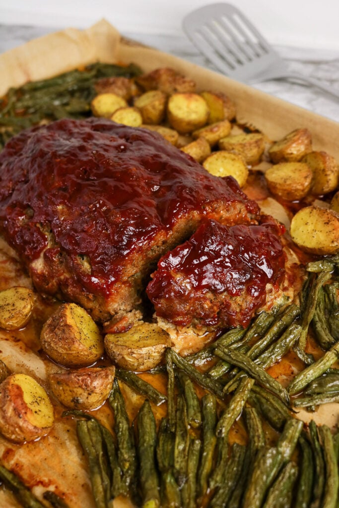 Sheet pan meatloaf and vegetables finished dish, ready to serve.