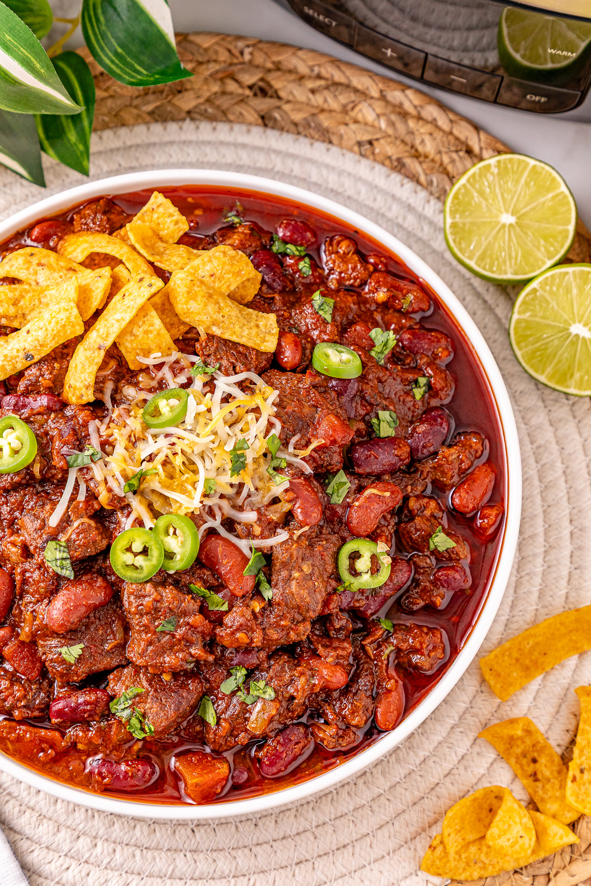 Steak chili con carne in a white bowl.