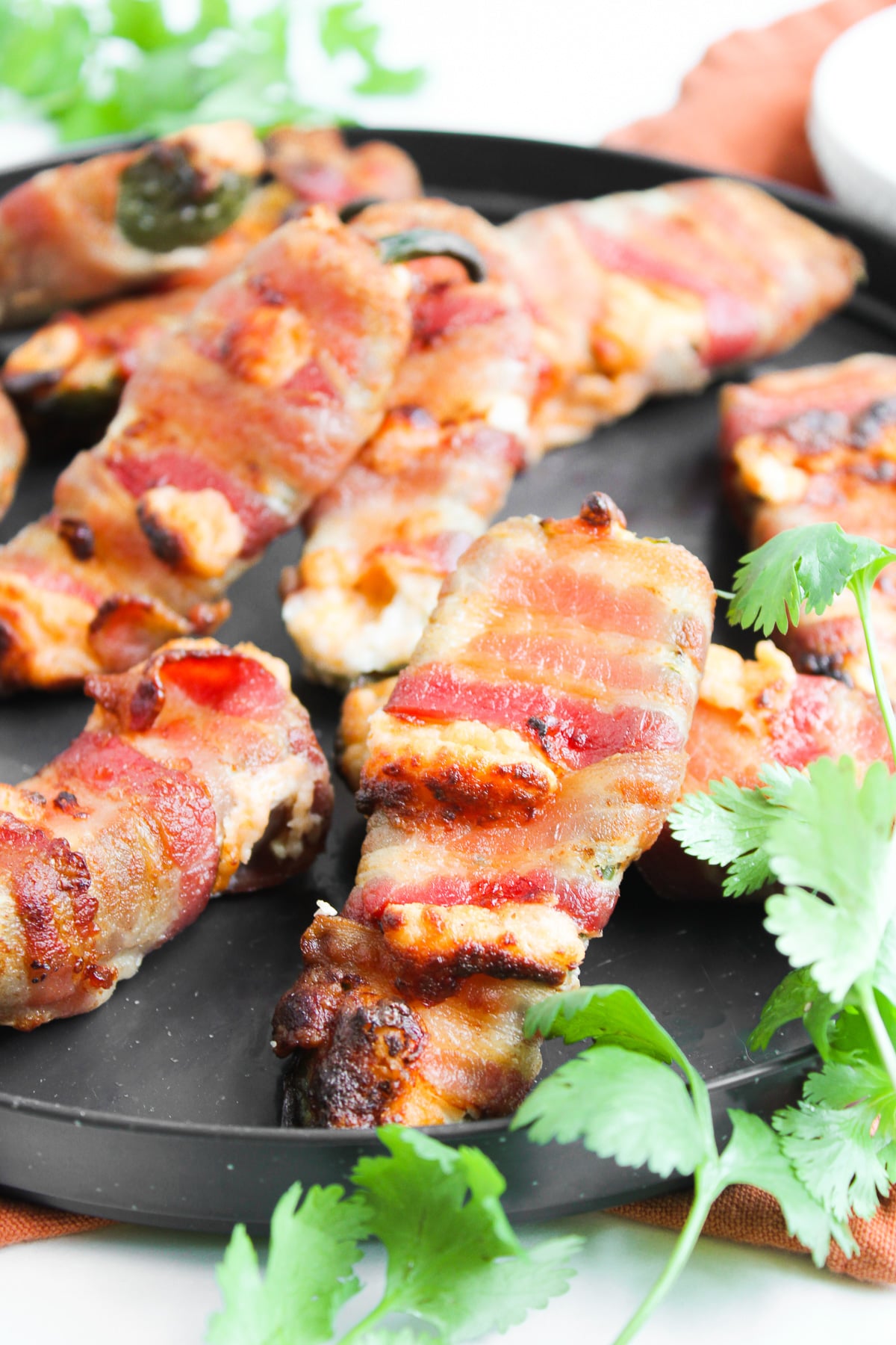 Air fryer bacon wrapped jalapeno poppers on plate served for a party.