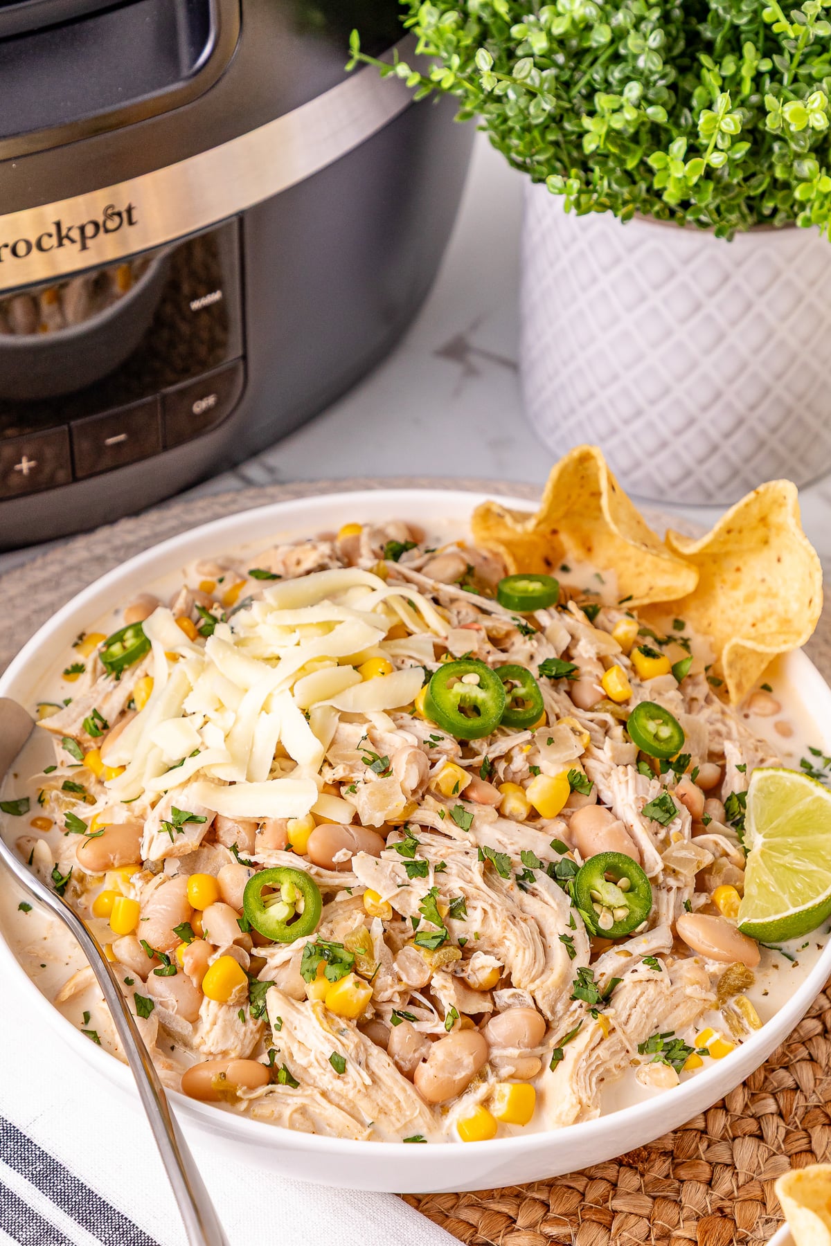 Crockpot white chicken chili in a white bowl.