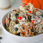 Halloween monster snack mix in a white bowl.