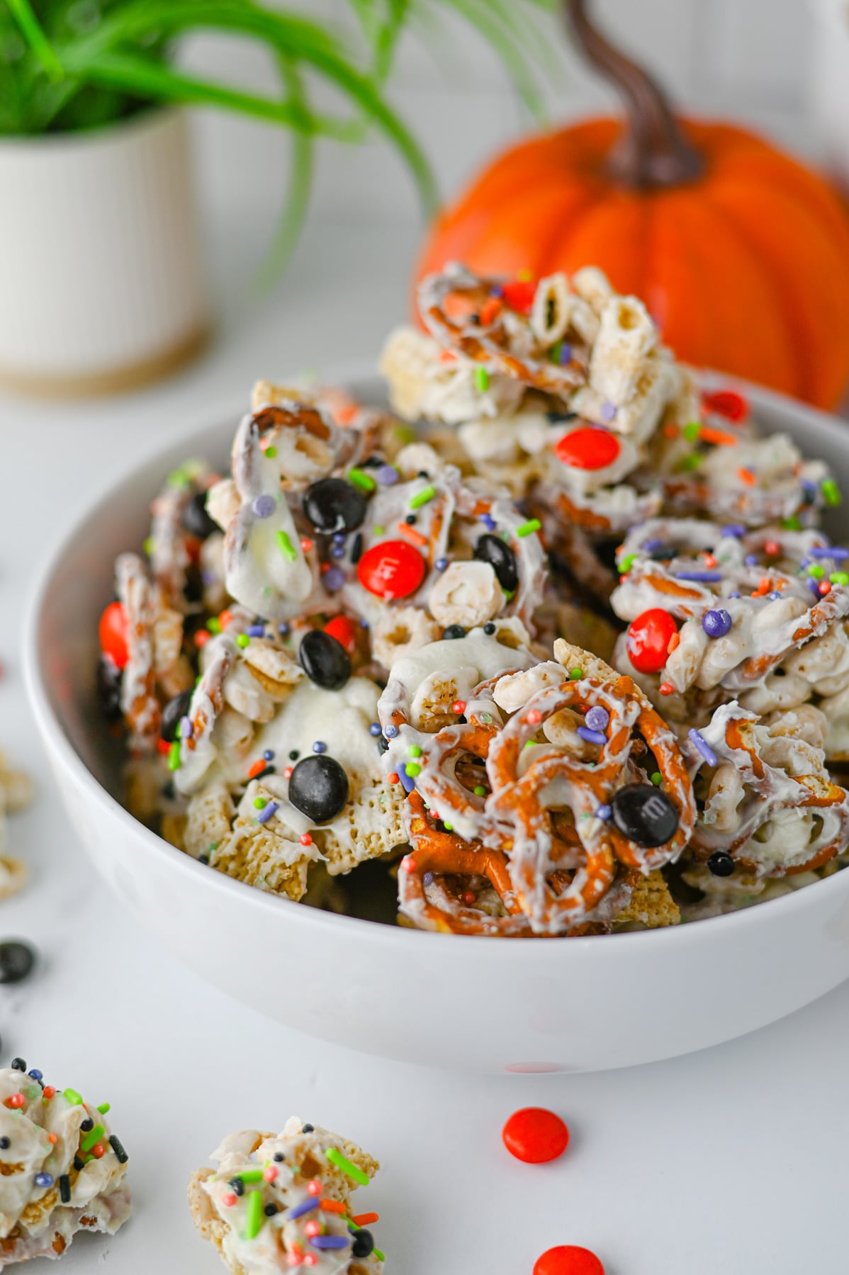 Halloween monster snack mix in a white bowl.