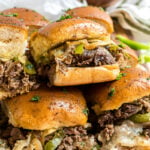 Sliders stacked on a white plate.