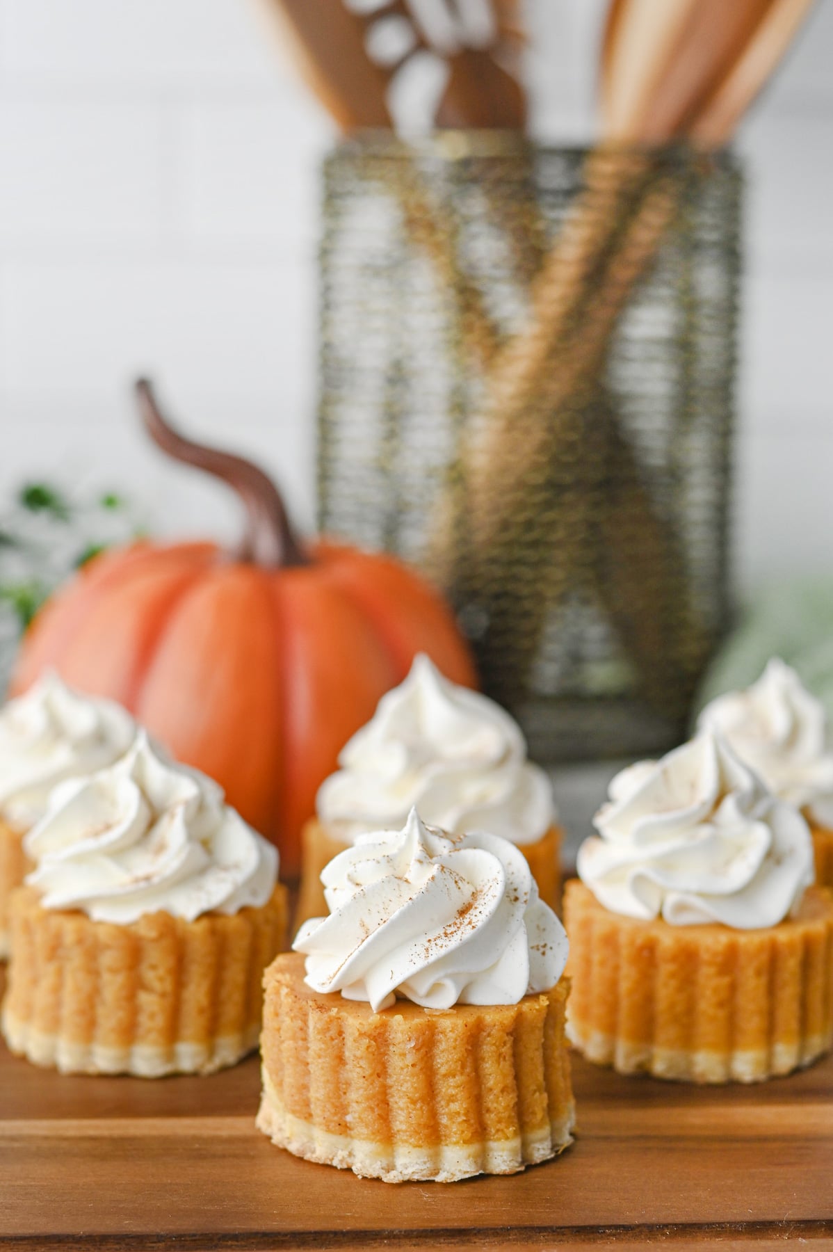 Pumpkin pie bites on wooden serving board.