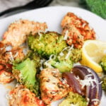 Sheet pan chicken and broccoli on a plate.