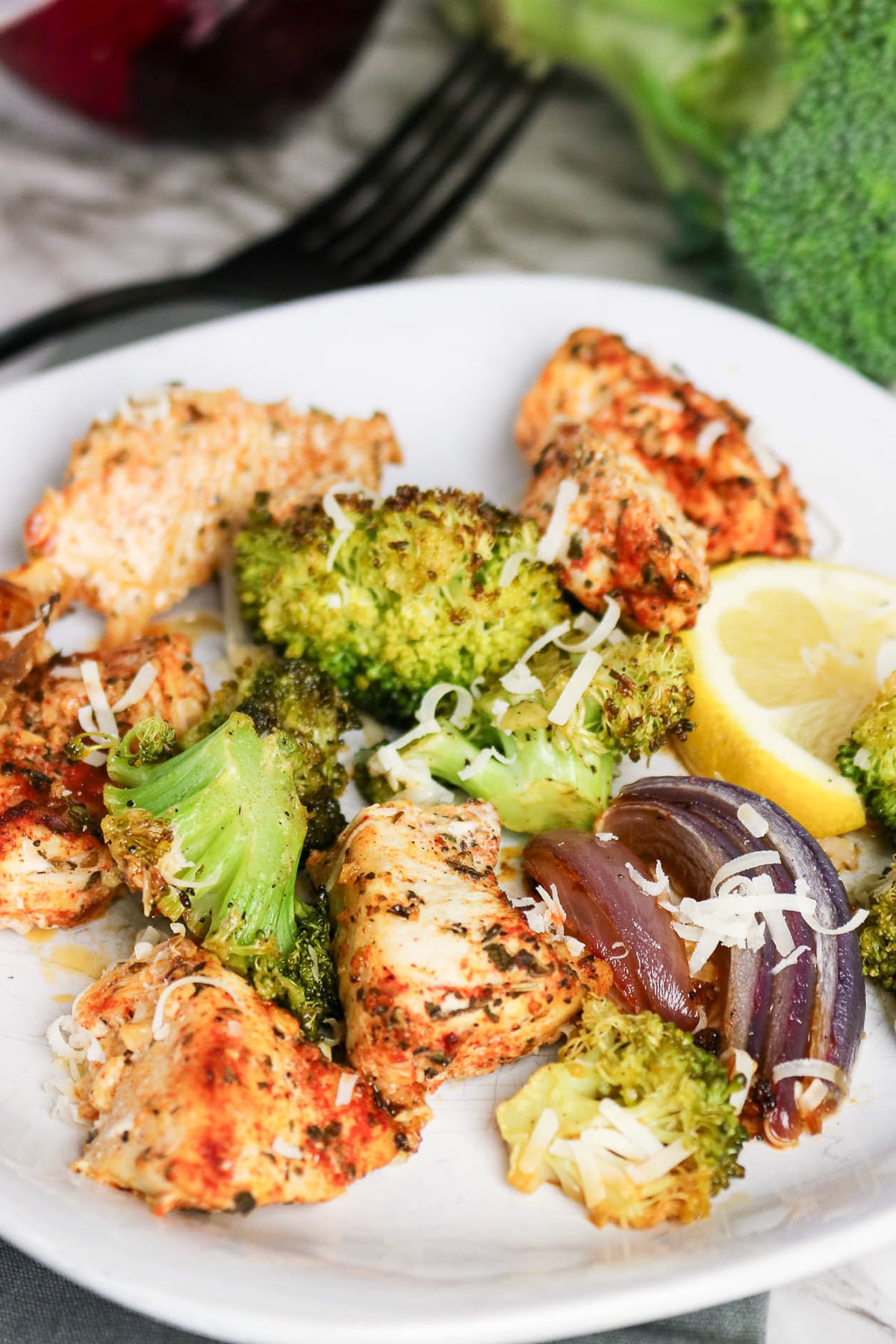 Sheet pan chicken and broccoli on a plate.