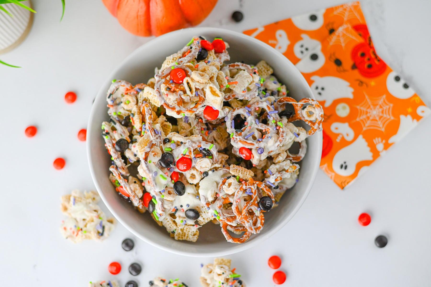 Halloween snack mix in a white bowl.
