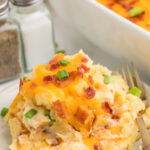 Twice baked mashed potato casserole on a white plate.