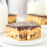 Chocolate chip millionaire bars on a white plate.