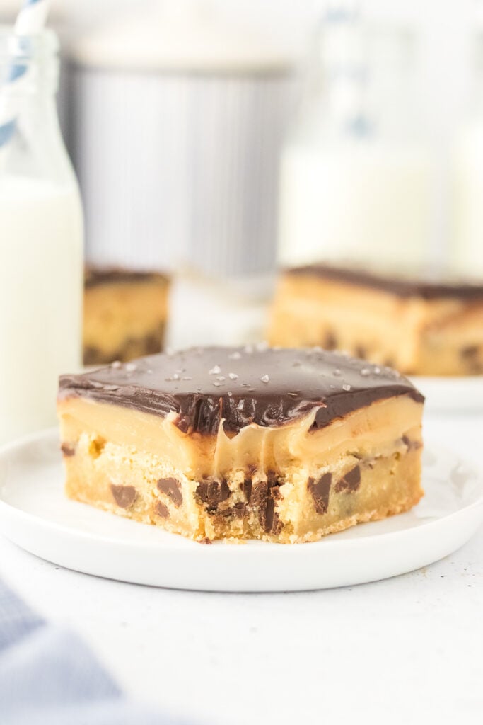 Chocolate chip millionaire bars on a white plate.