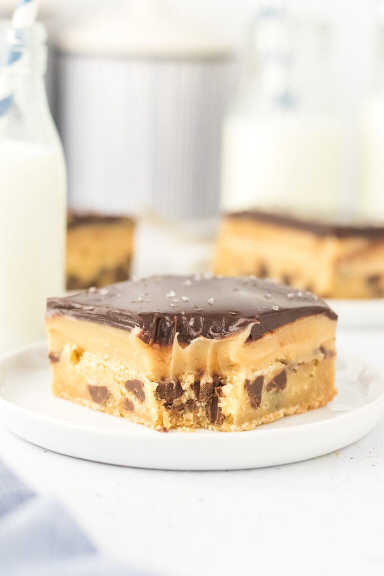 Chocolate chip millionaire bars on a white plate.