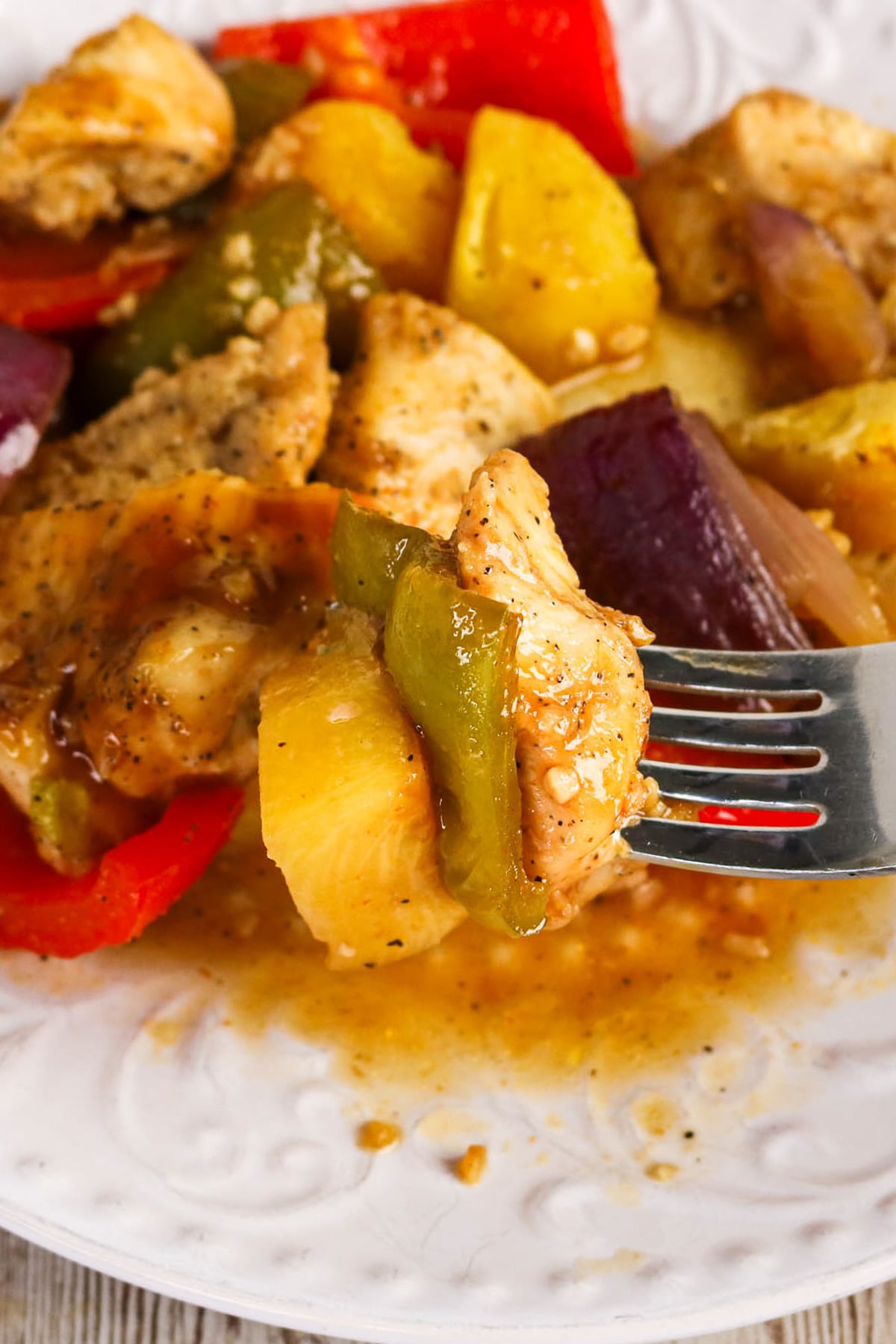 Close up bite shot of Hawaiian sheet pan chicken.