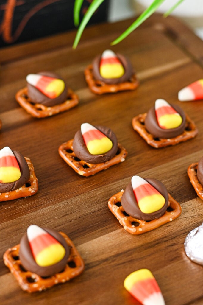 Candy corn pretzel bites on wooden serving tray.
