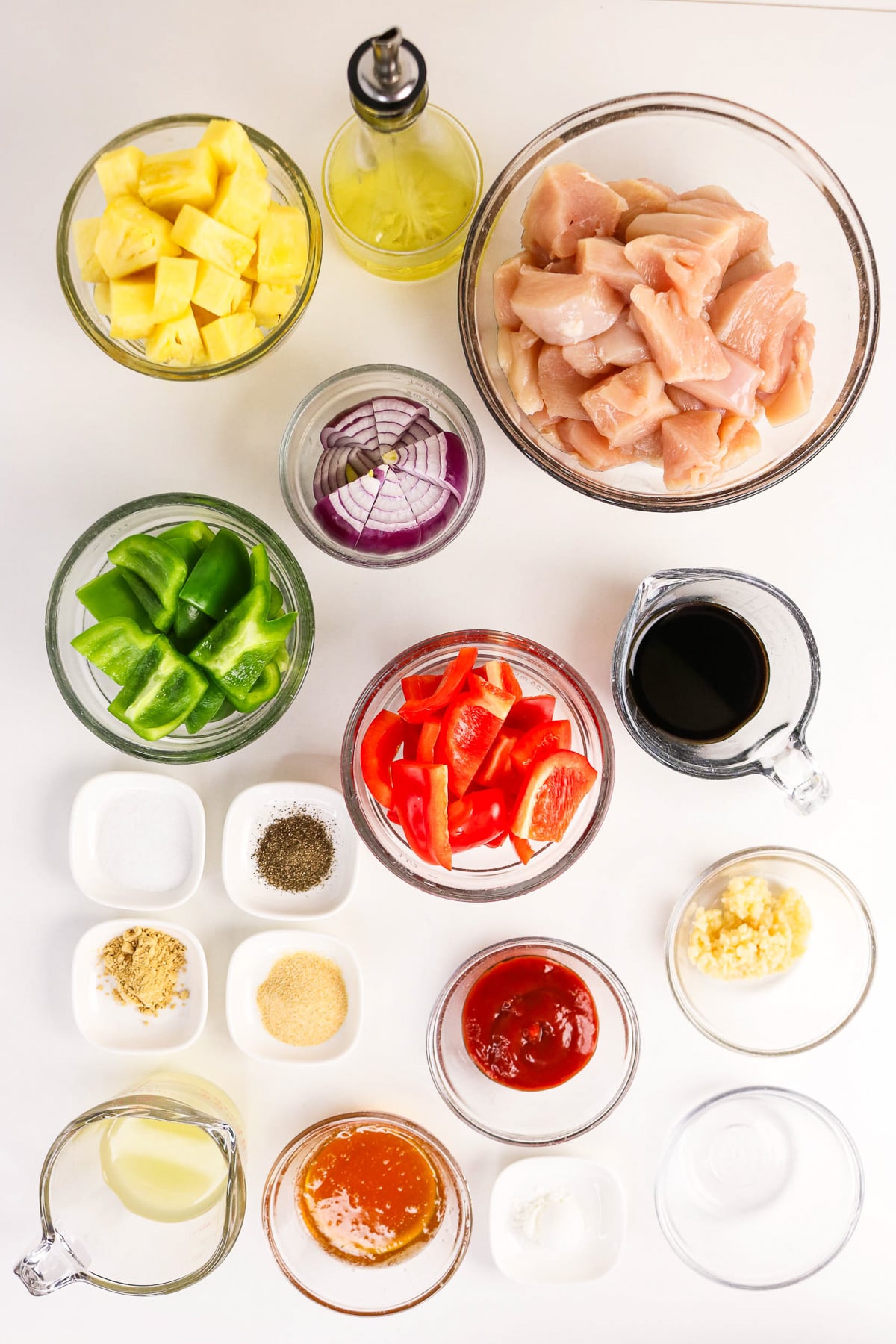 Ingredients for Hawaiian sheet pan chicken laid out on kitchen counter in small bowls.