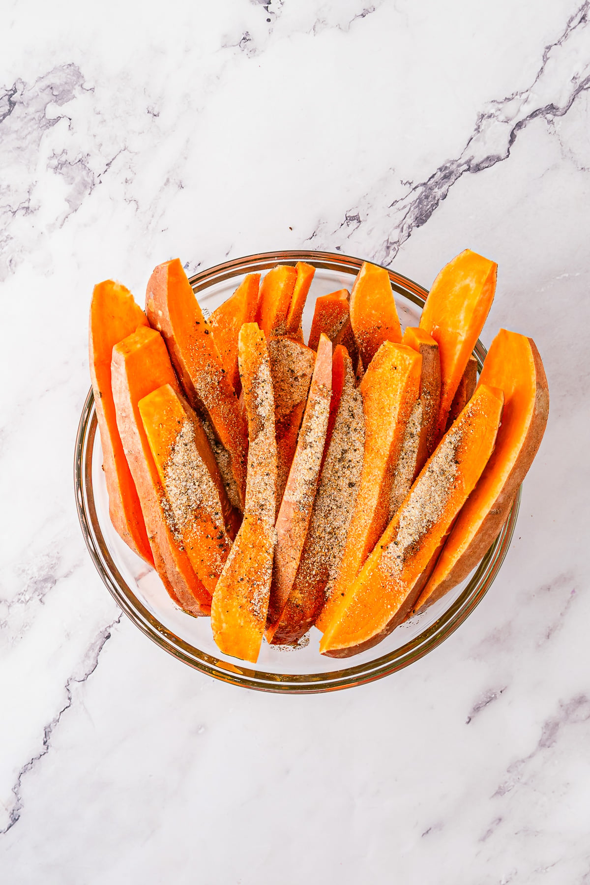 Cut sweet potatoes in glass bowl.