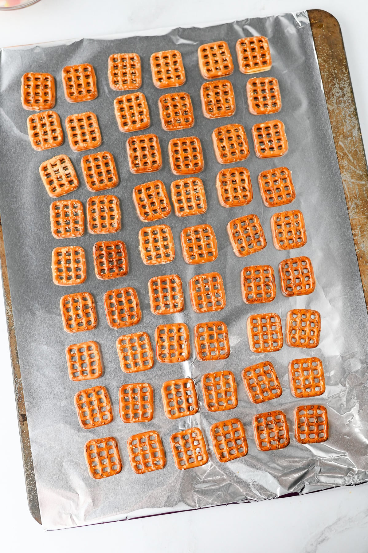 Pretzel snaps on lined baking sheet.