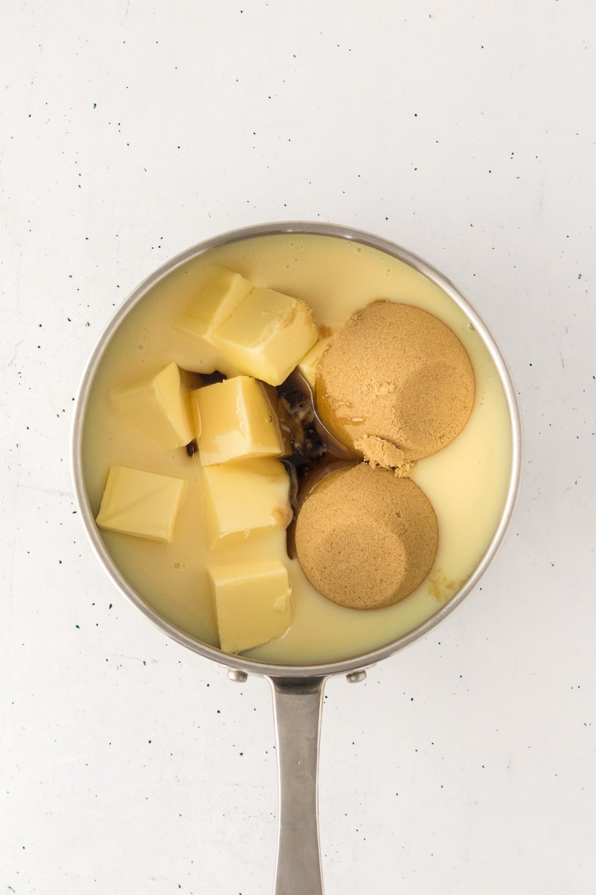 Sweetened condensed milk, butter, brown sugar, and corn syrup in saucepan.