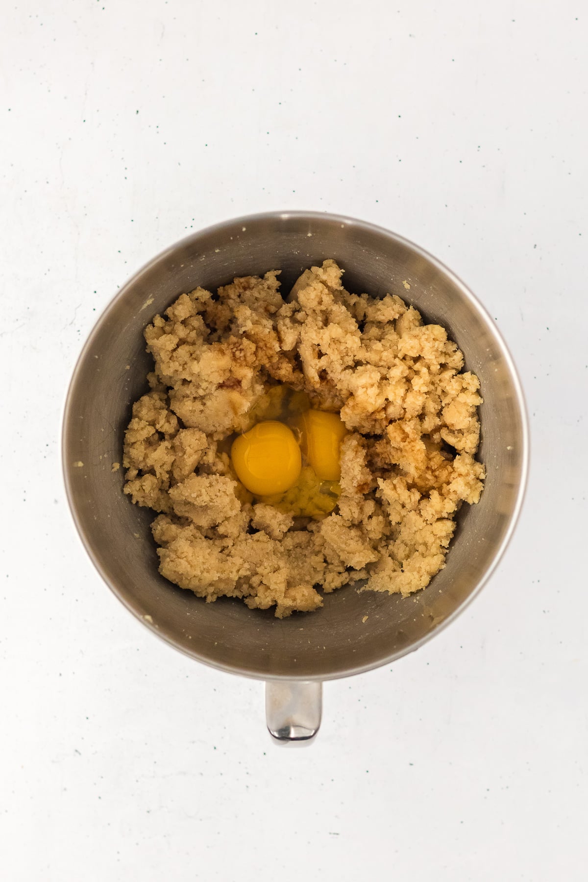Butter, sugar, vanilla and eggs in bowl from stand mixer.