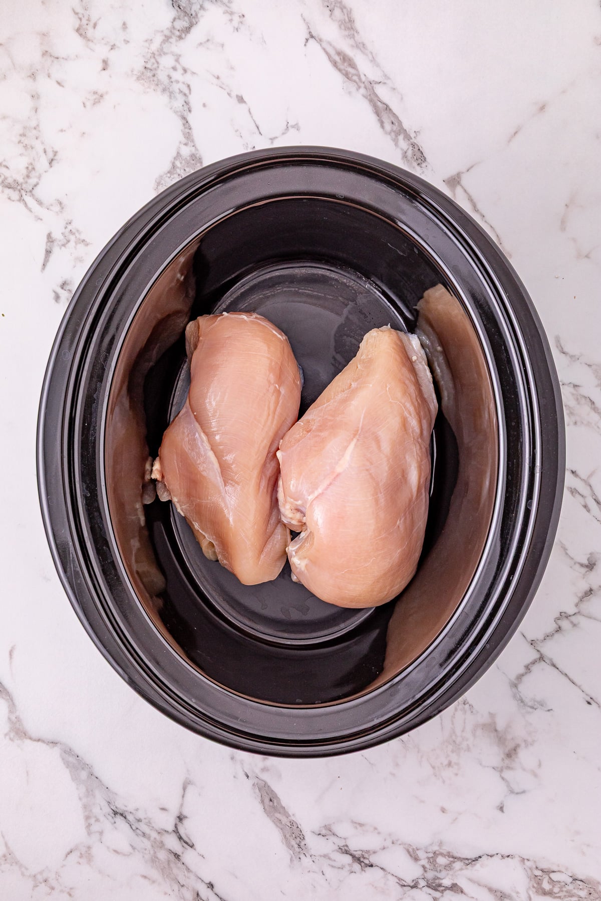 Boneless, skinless chicken breat in bottom of crockpot.
