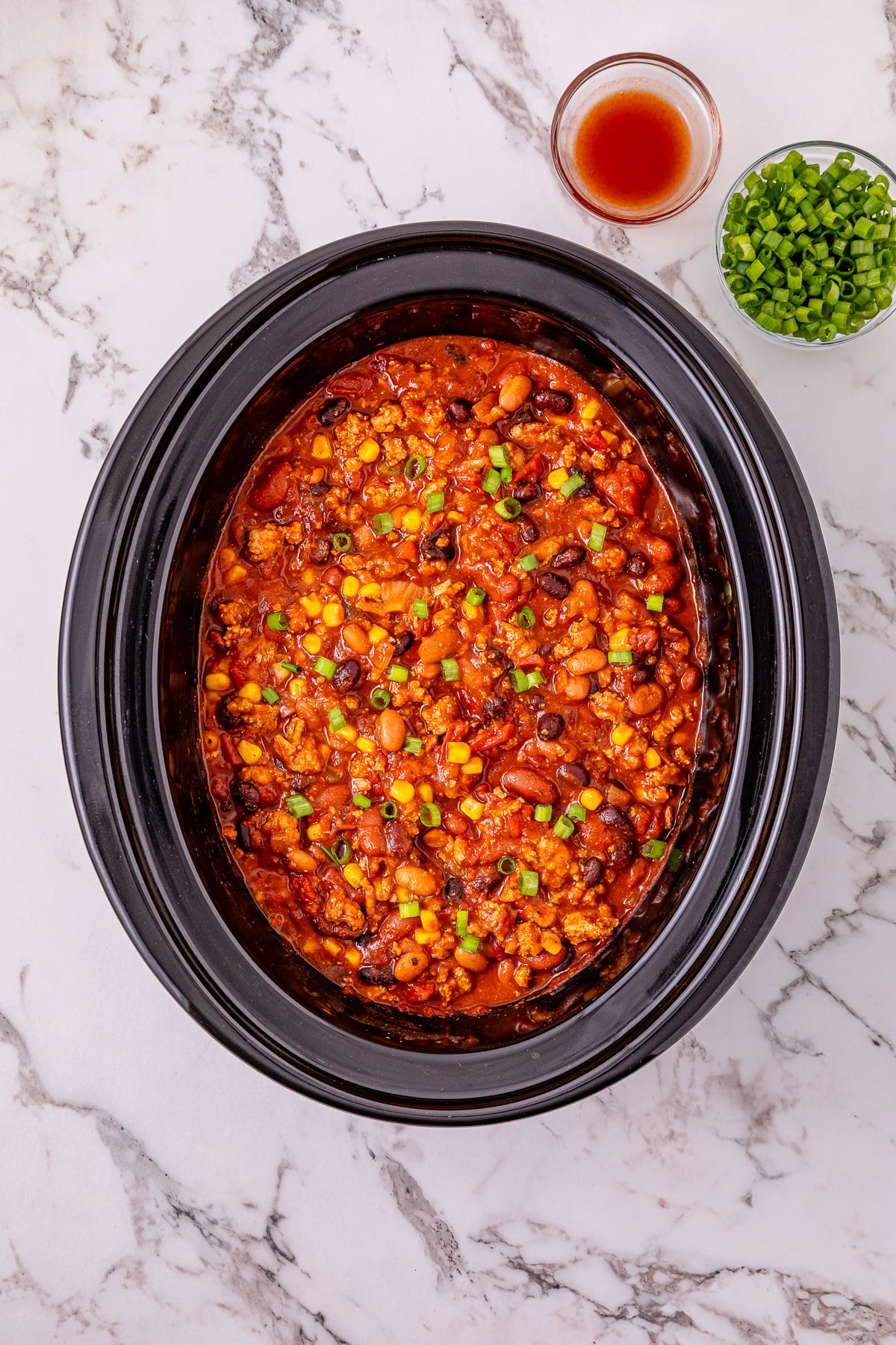 Finished dish of crockpot turkey chili ready to be garnished and served.