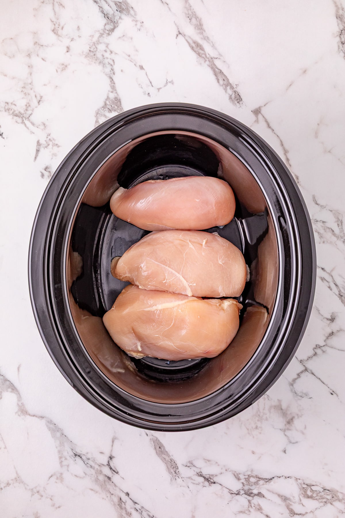 Chicken breasts placed in bottom of crockpot.