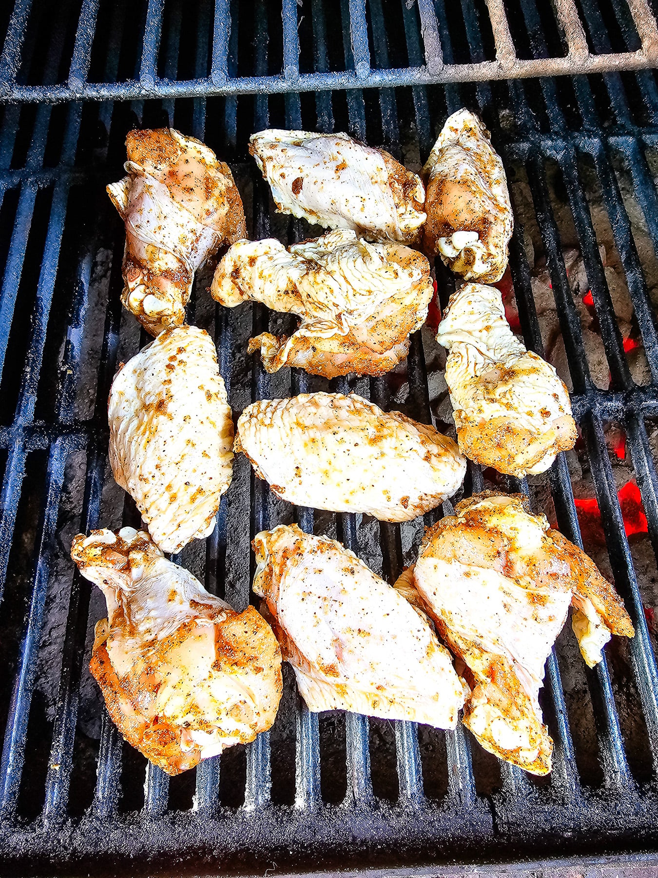 Chicken wings placed on grill.