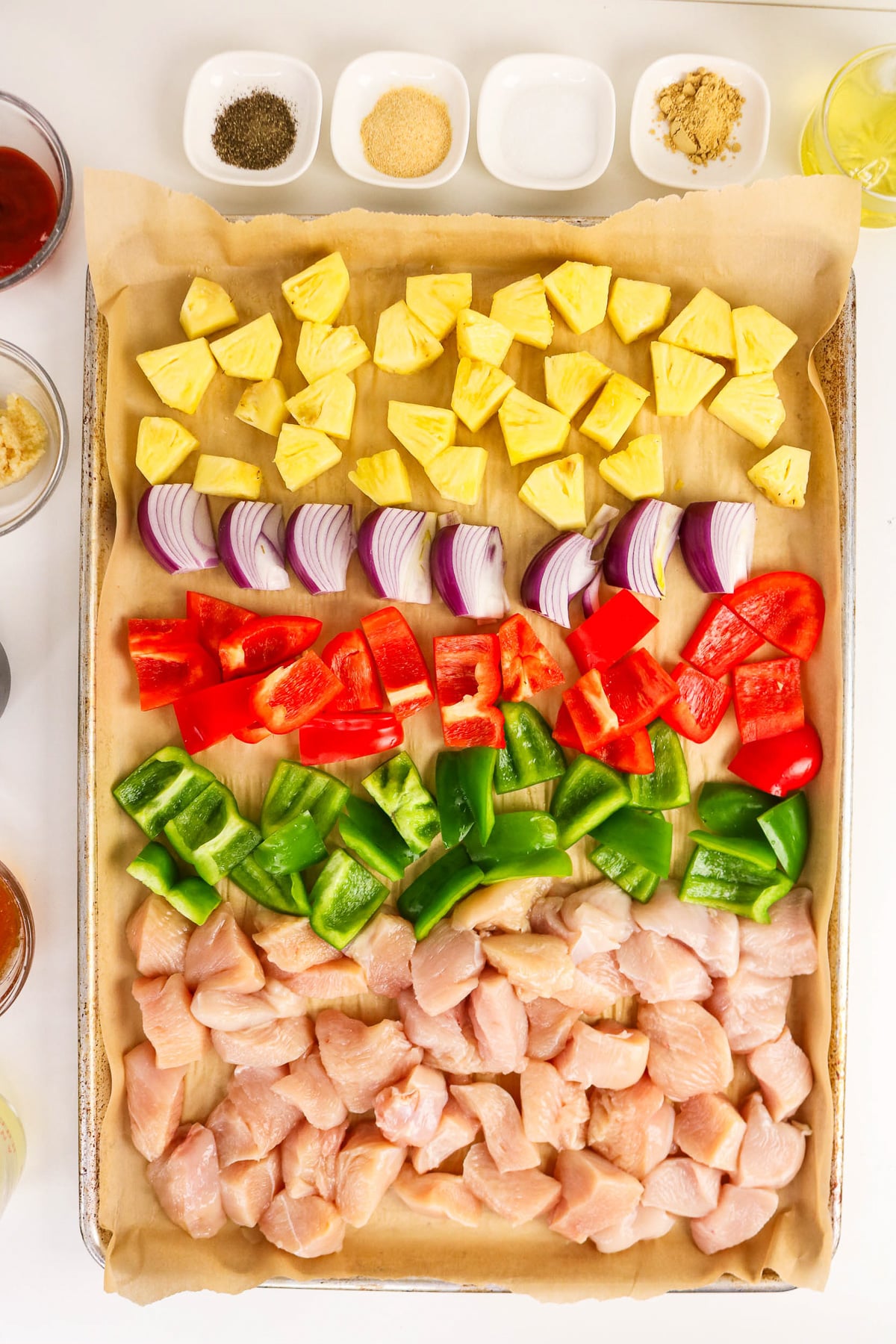 Chopped ingredients on parchment lined baking dish.