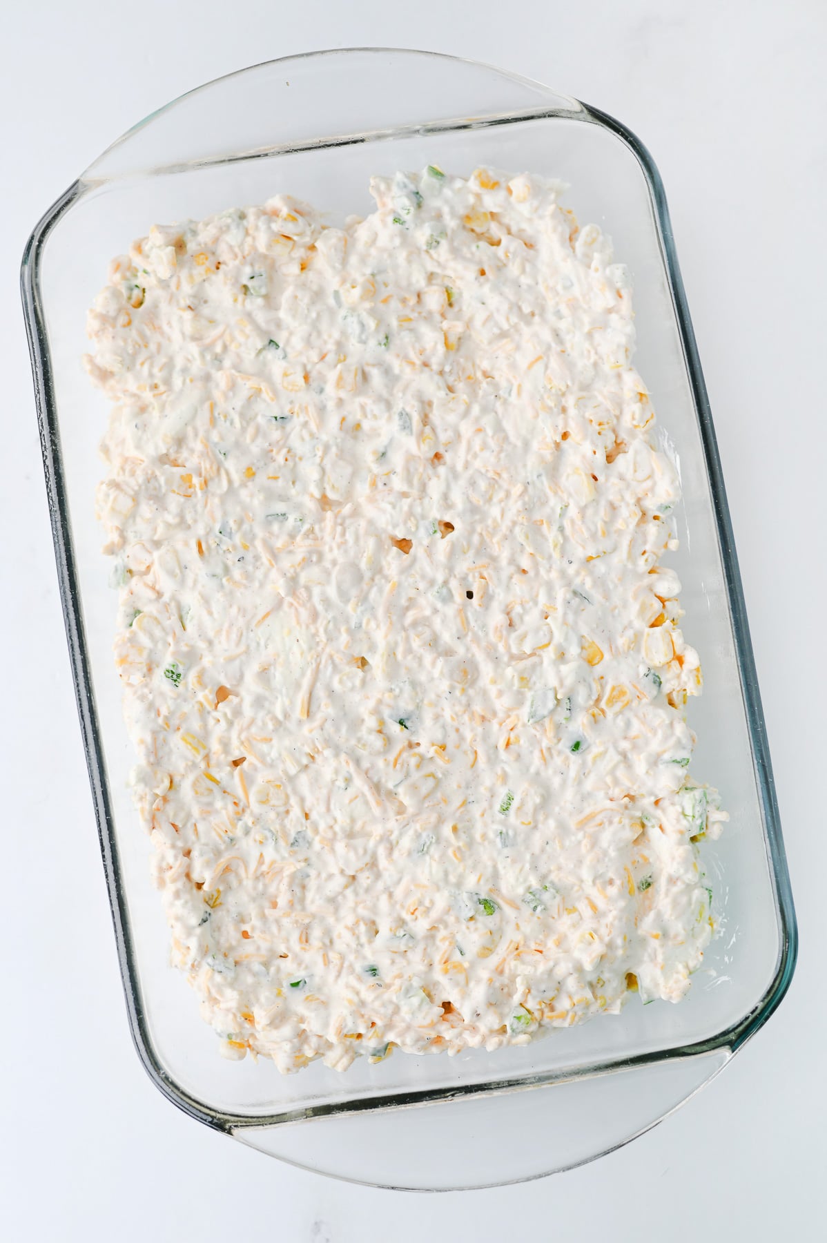 Cream cheese mixture is spread in bottom of baking dish.