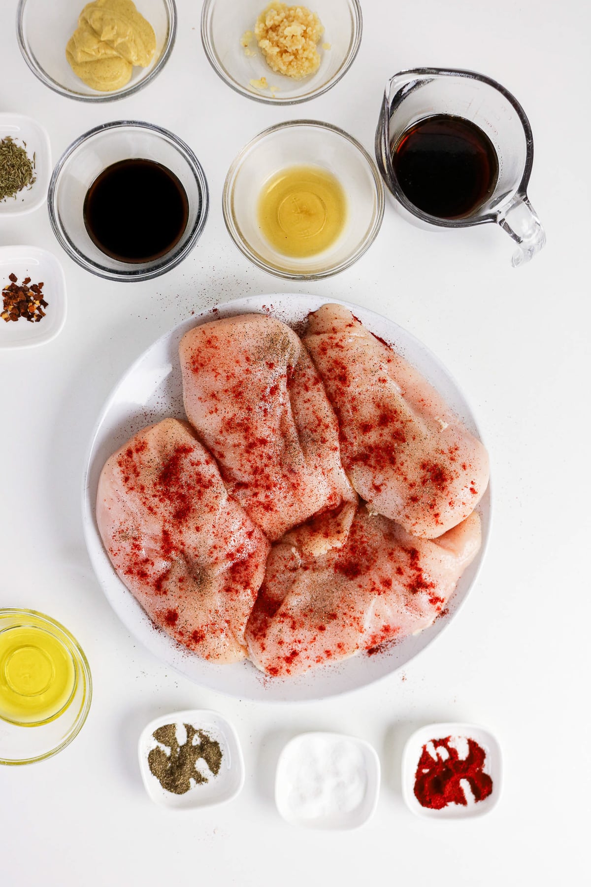 Seasoned chicken on a white plate.