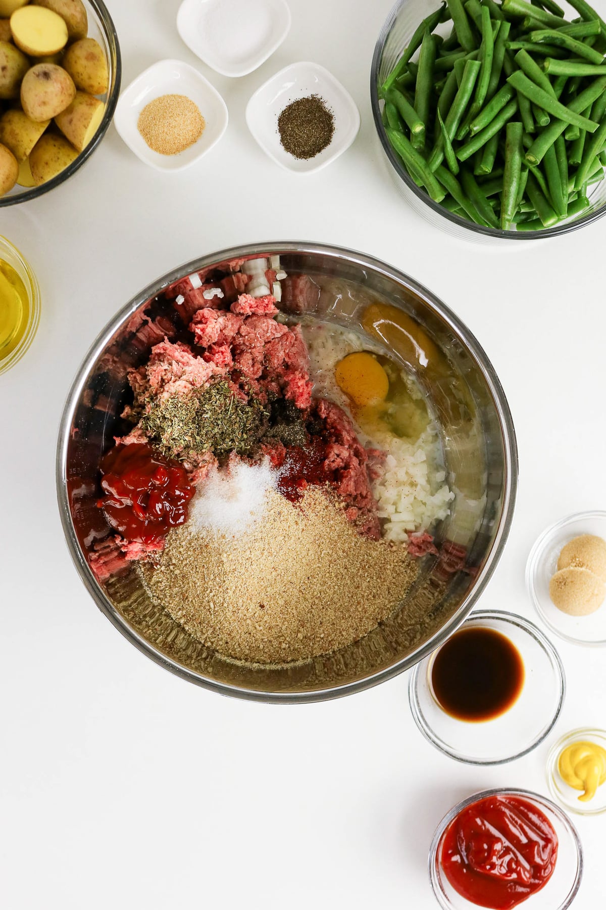 Meatloaf ingredients in bowl, ready to be mixed.