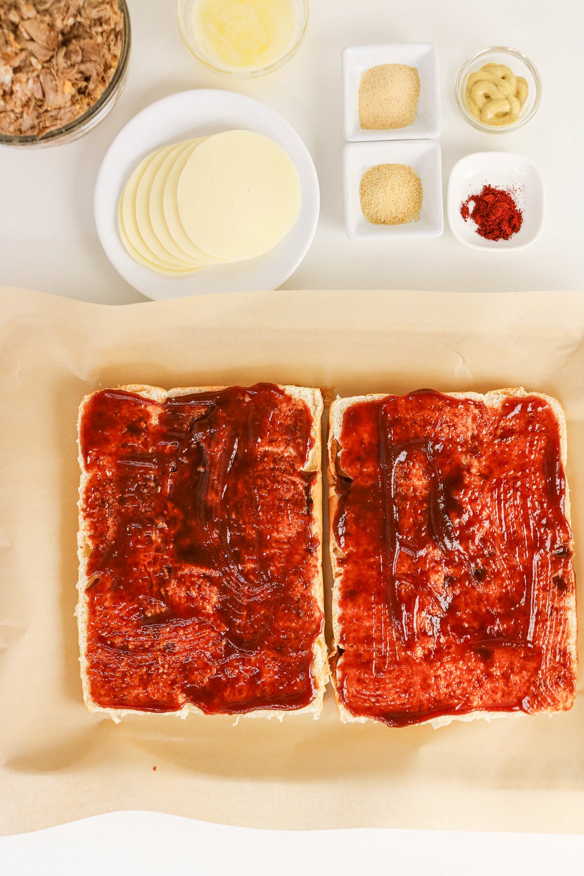 Cut rolls with bbq sauce spread out evenly on tops and bottoms.