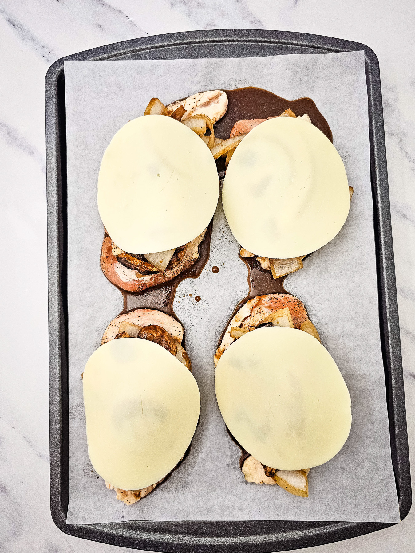Provolone cheese is added to the chicken.