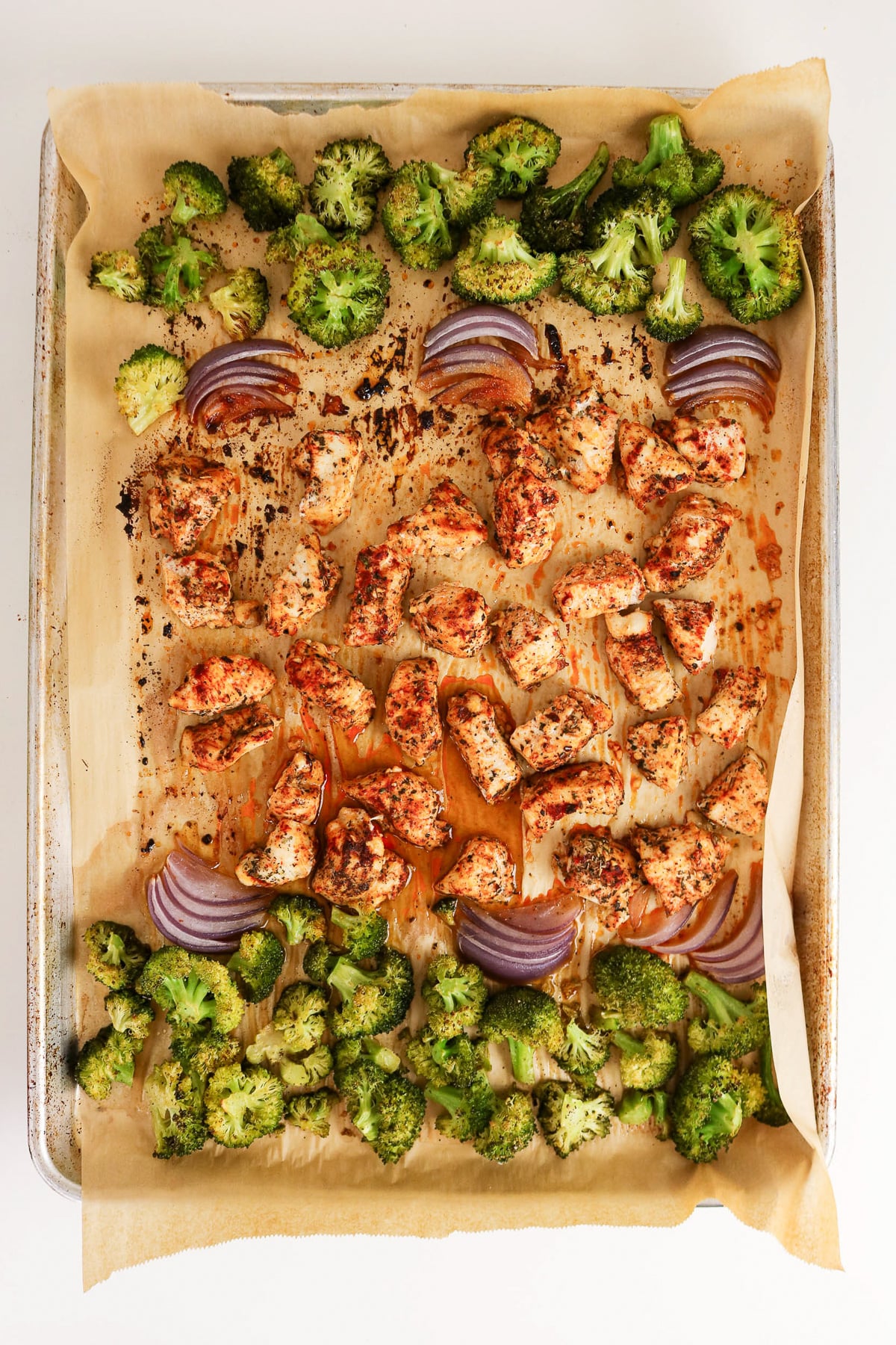 Finished dish of sheet pan chicken and broccoli.