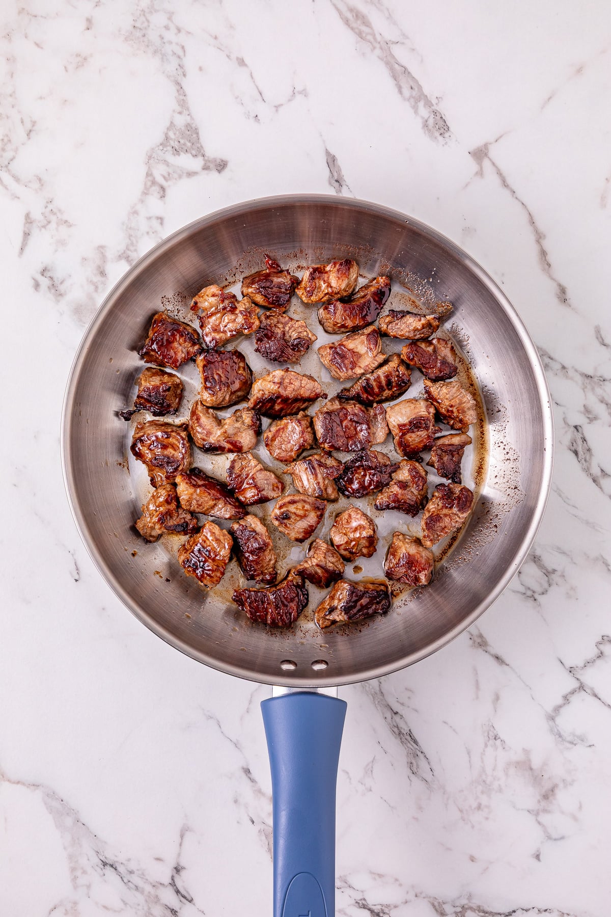 Cut up meat in skillet.