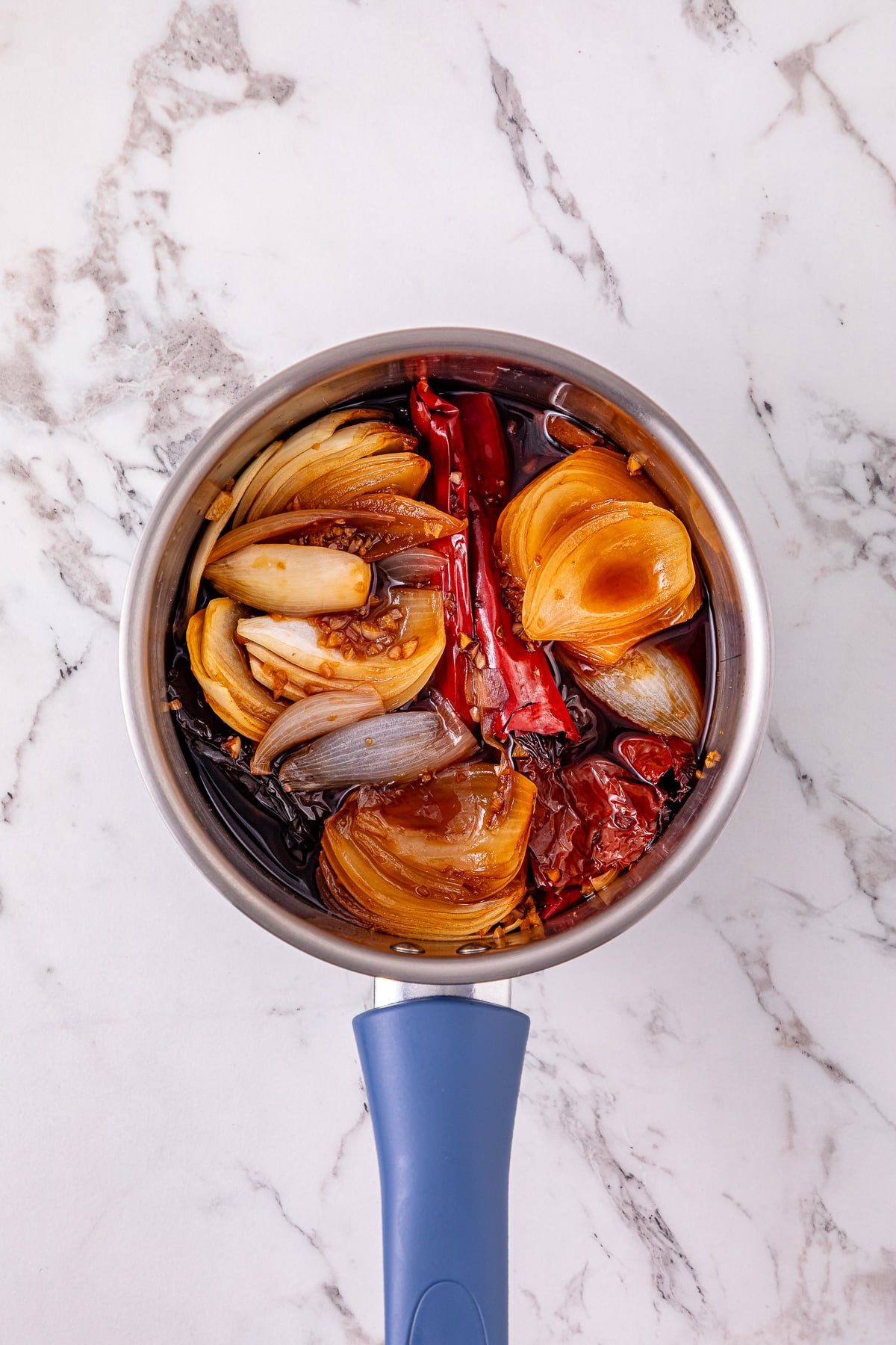 Chiles in saucepan with beef broth.
