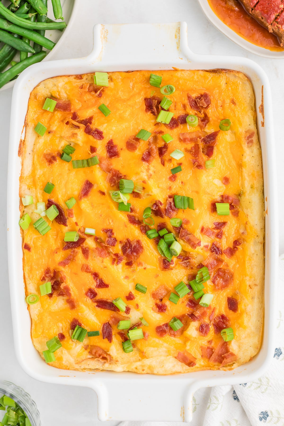 Green onion are sprinkled on top of the potato mixture.